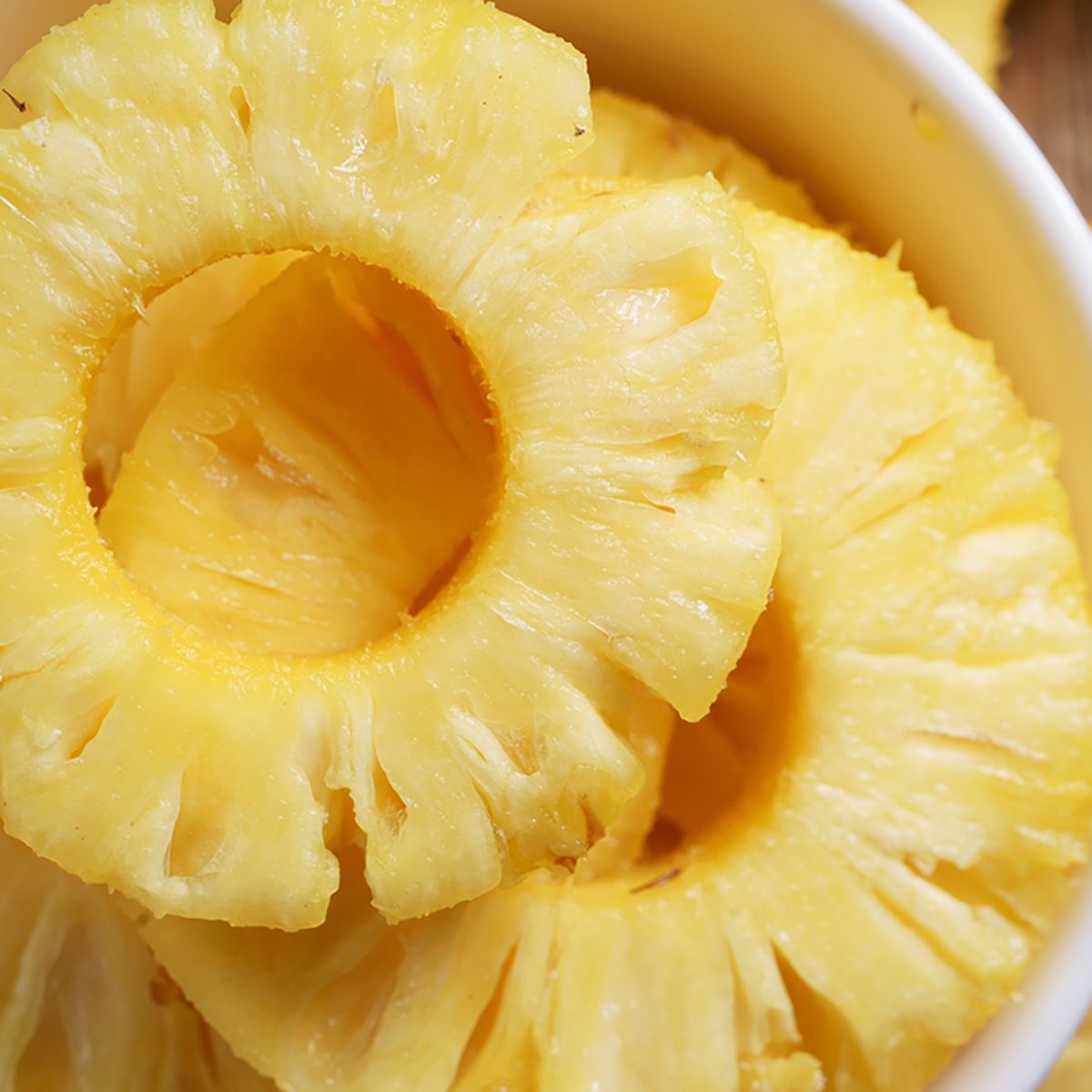 pineapple. details of fresh pineapple on woodenbackground;