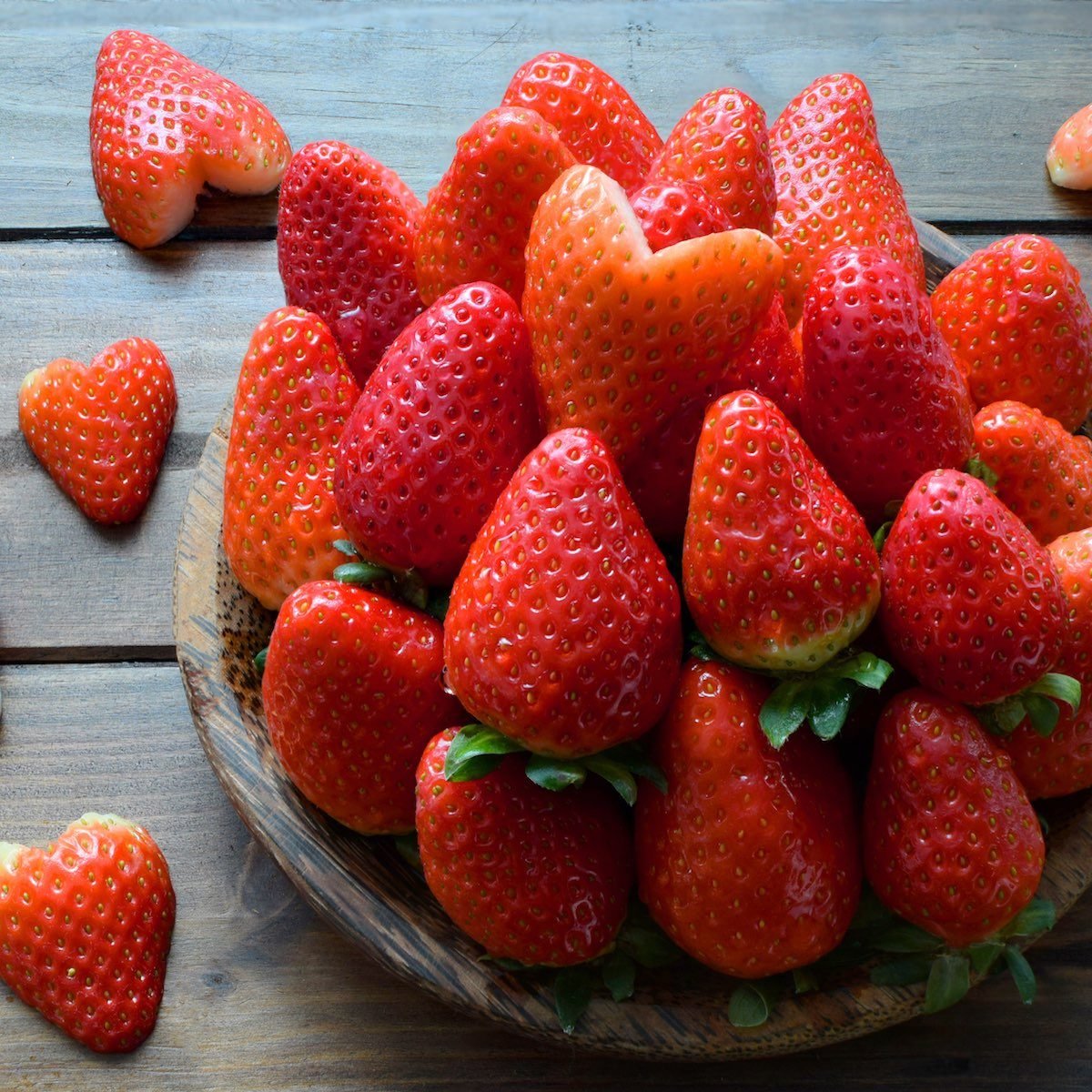 Fresh Strawberry and strawberry heart in wooden plate on wooden