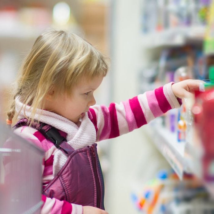Kid pulling item off of a shelf
