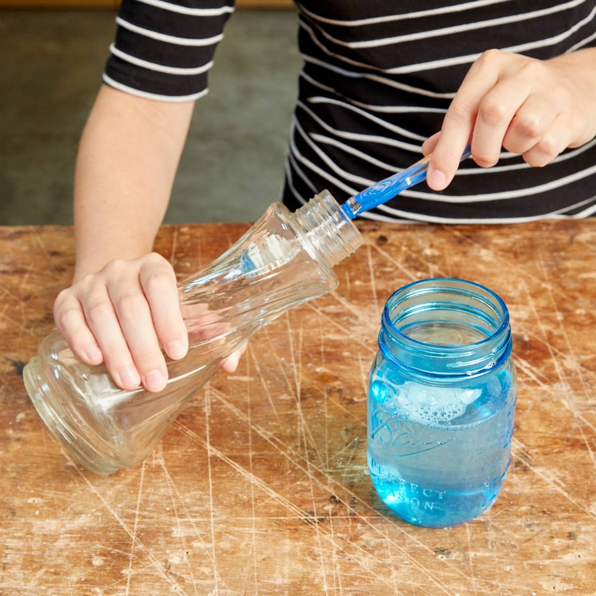 Using a toothbrush to clean a vase