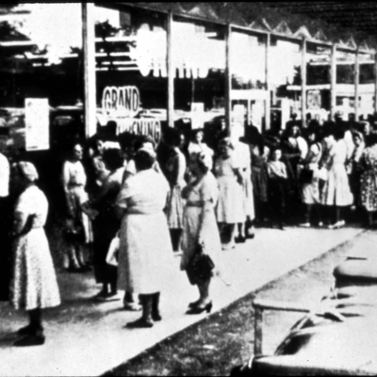 Black and white photo of people standing outside of a Walmart
