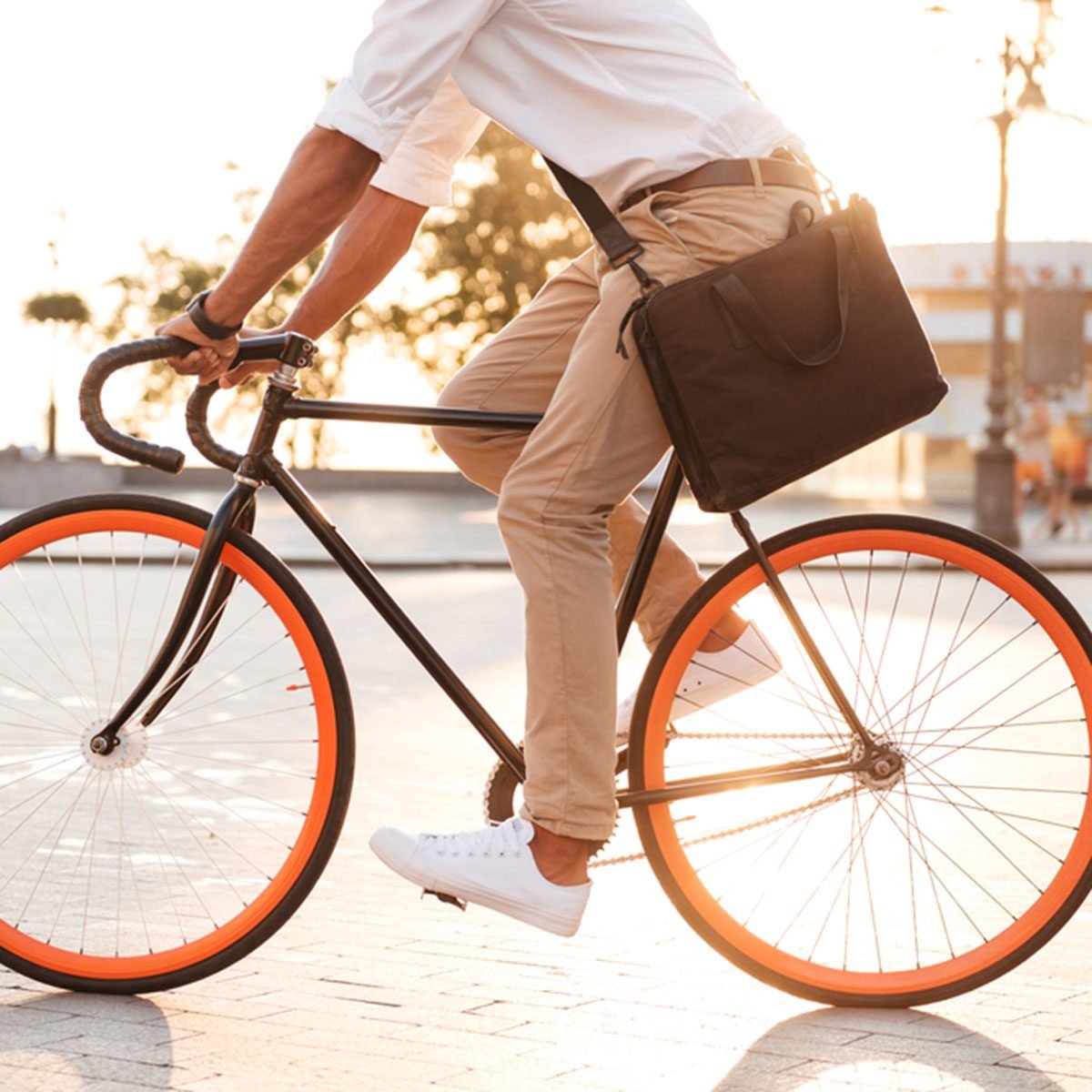 Cropped picture of handsome young african man early morning with bicycle