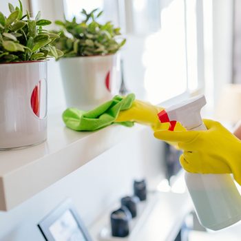 Woman wearing yellow rubber protective gloves and cleaning white shelf.; Shutterstock ID 546648745; Job (TFH, TOH, RD, BNB, CWM, CM): Taste of Home