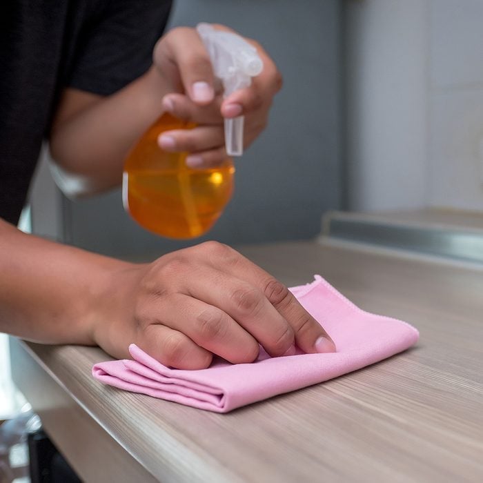 cleaning her house using a spray and a duster cleans; Shutterstock ID 1069028468; Job (TFH, TOH, RD, BNB, CWM, CM): Taste of Home