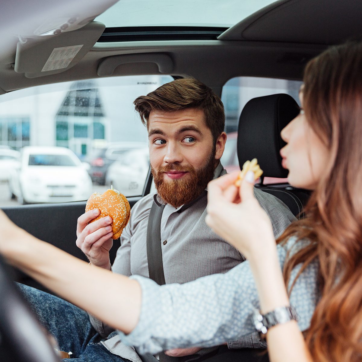 Couple eating in car.