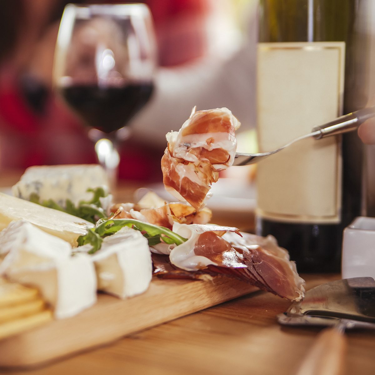 Friends Drinking Wine And Eating Cheese