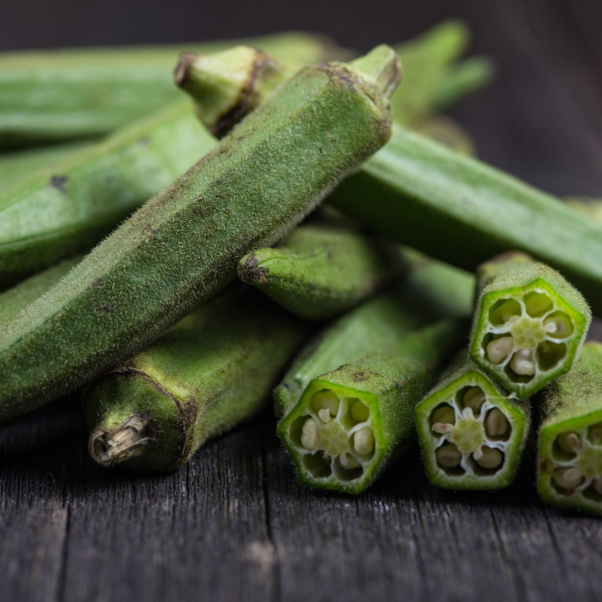 Farm fresh raw okra on wooden rustic table