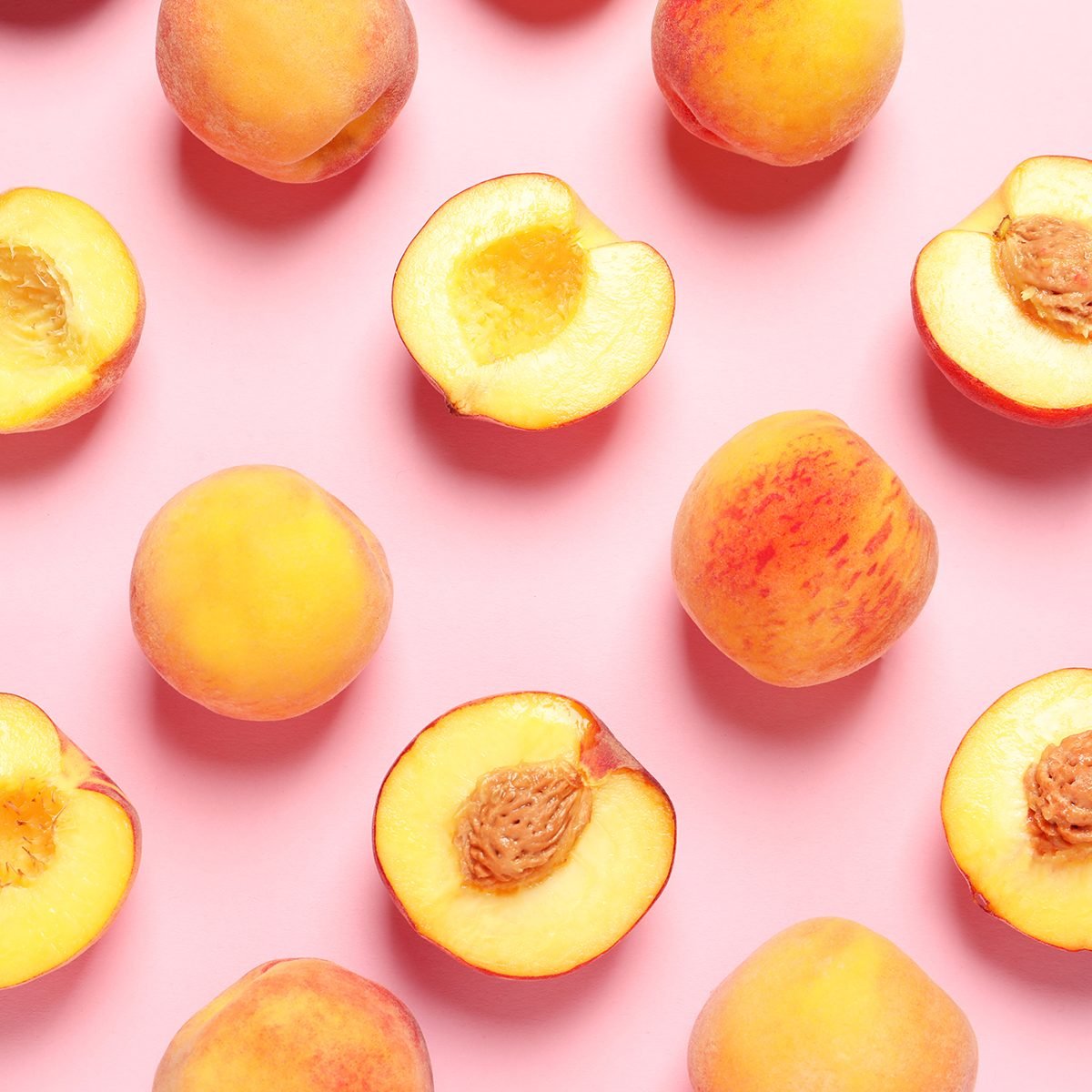 Flat lay composition with ripe peaches on color background
