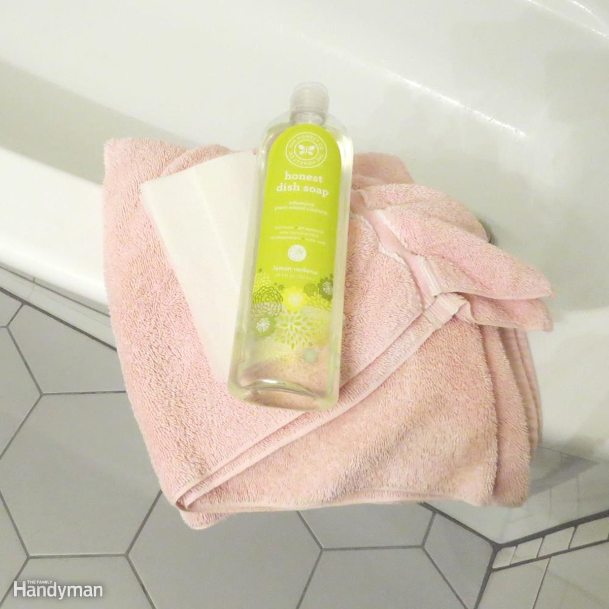 Bottle of cleaning on pink towel