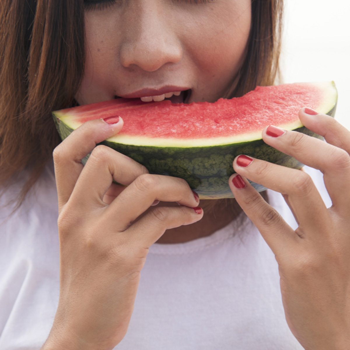 Young woman eating watermelon.