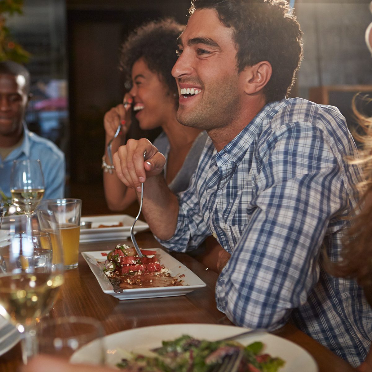 Group Of Friends Enjoying Meal In Restaurant
