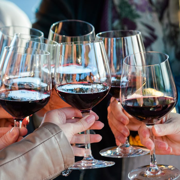 Wining with friends. Seven friends cheering