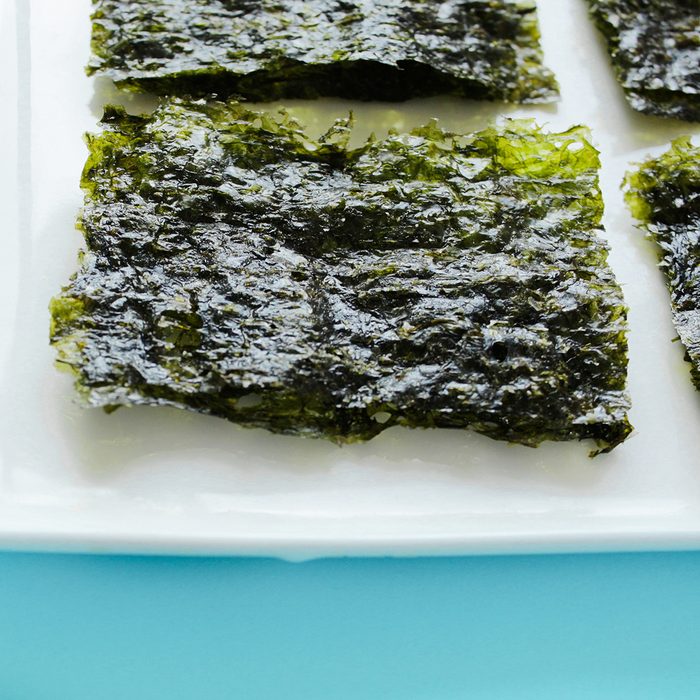 Dry korean organic seaweed isolated on blue background.