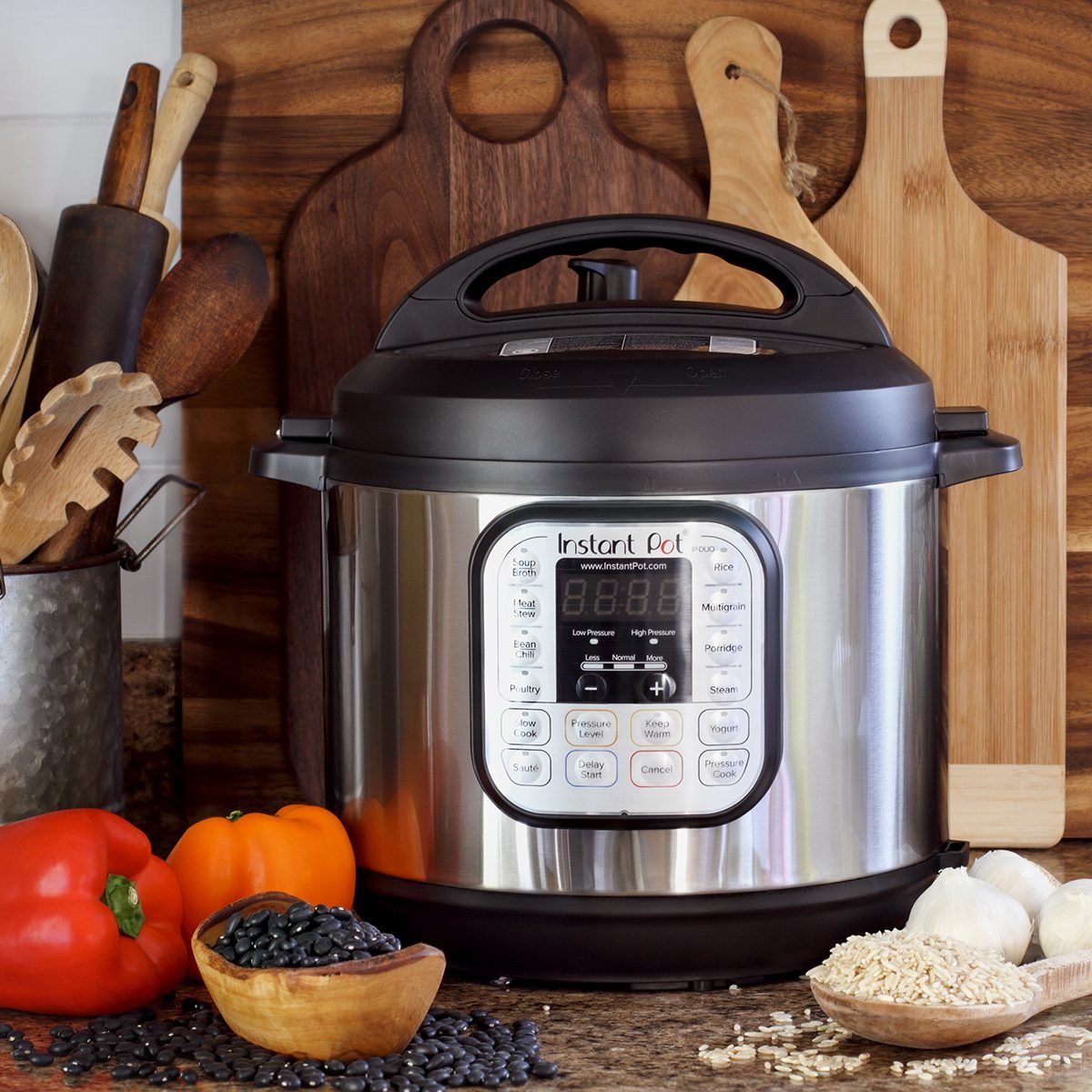 Instant Pot pressure cooker on kitchen counter with beans and rice.