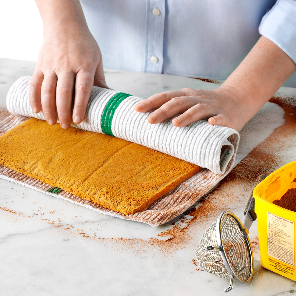 rolling a cake into a Yule log role shape