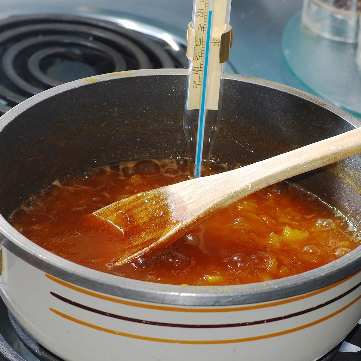 Apricot juice bubbling in sauce pan as candy thermometer reading passes the boiling point.; Shutterstock ID 107252102; Job (TFH, TOH, RD, BNB, CWM, CM): TOH