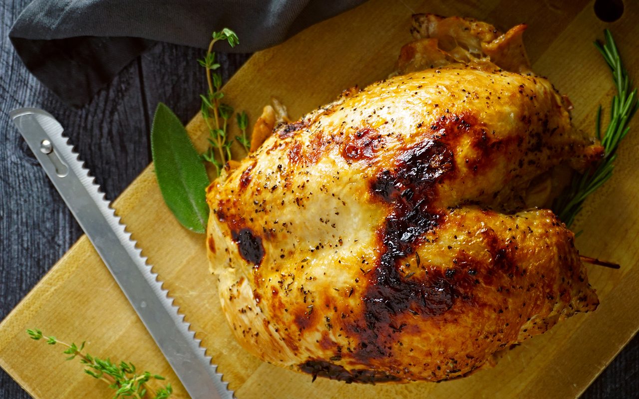 fully cooked instant pot turkey breast on a carving board after broiling to crisp the skin