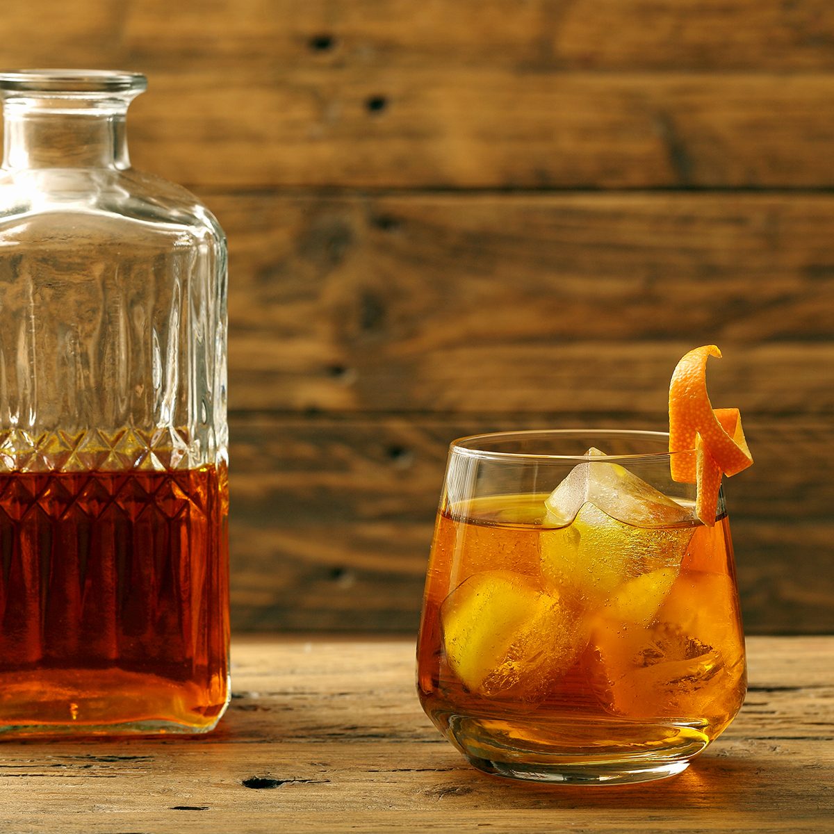 cocktail drink wiskey and orange on rustic background