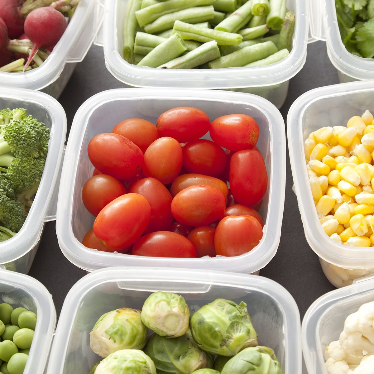 Different types of veggies each in a platic container