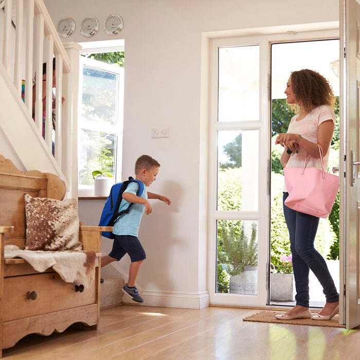 Boy Leaving Home For School With Mother