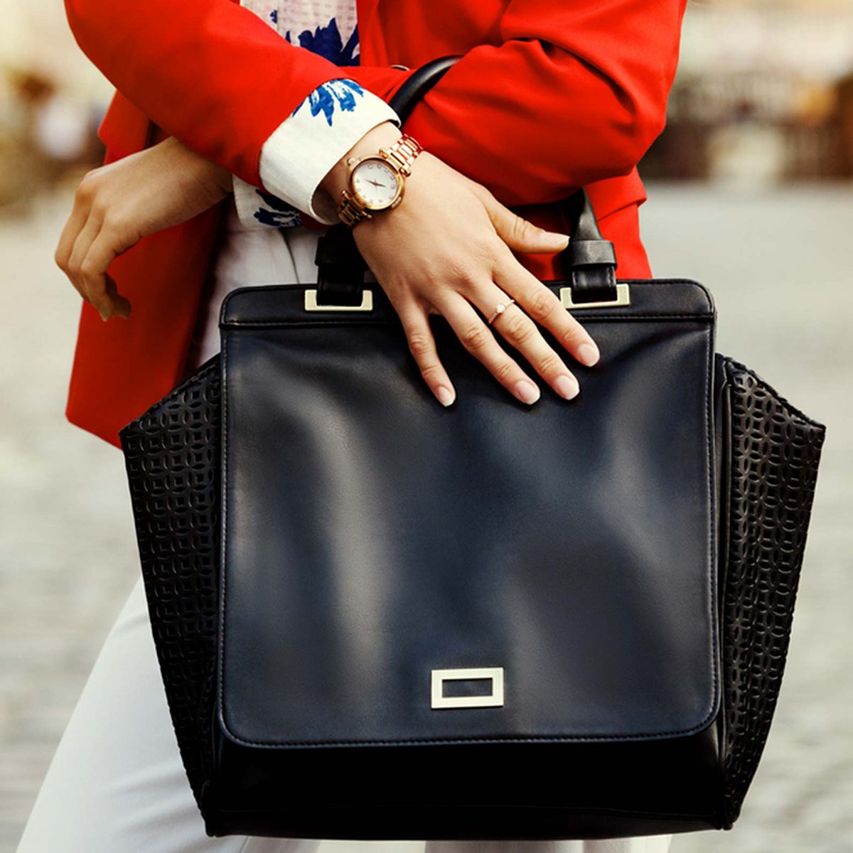 Woman in red suit holding purse