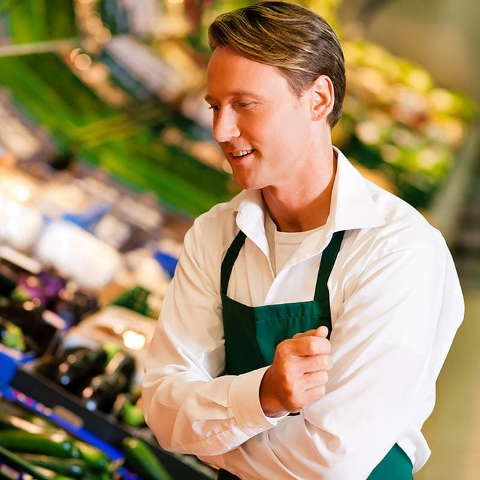 Shop assistant in a supermarket at the vegetable shelf checking the stuff for sale; Shutterstock ID 63574951; Job: RD