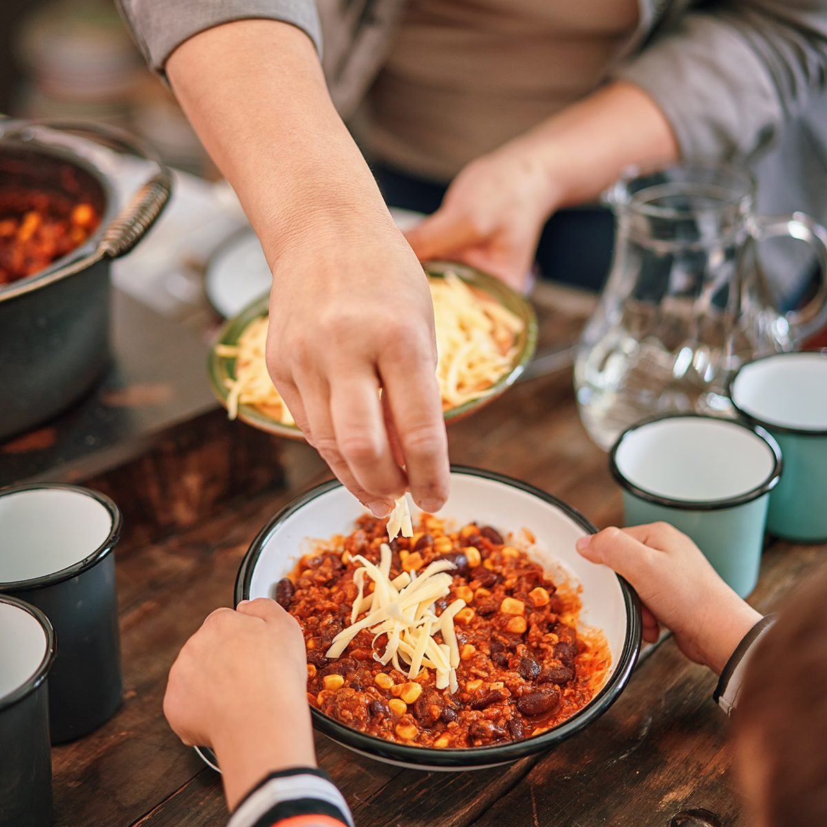 Young Family Eating Chili Con Carne