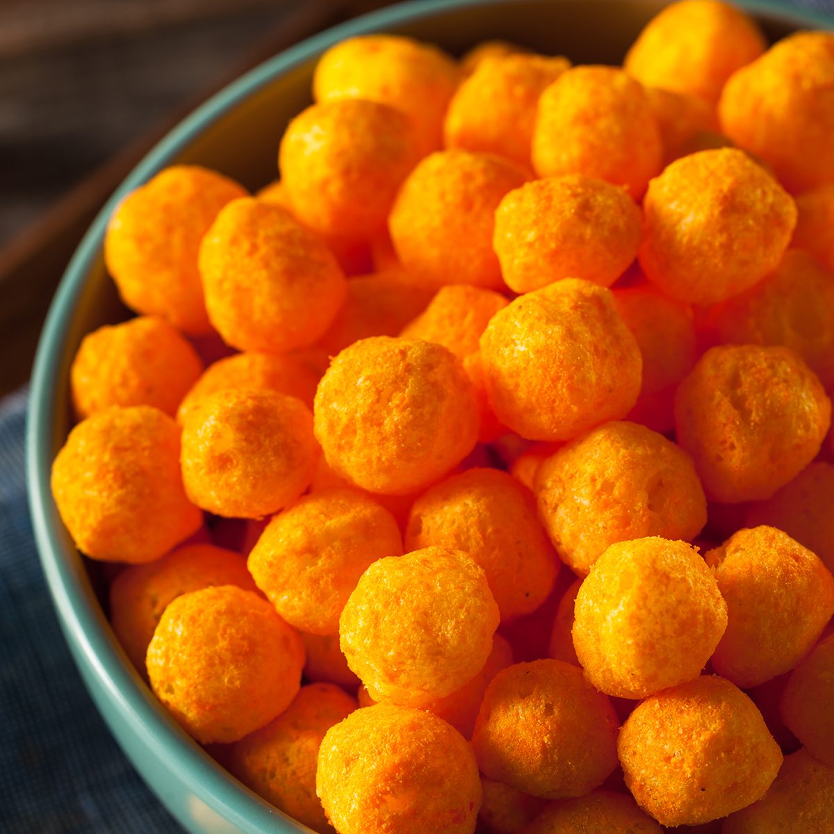 Unhealthy Cheesy Cheese Puffs in a Bowl
