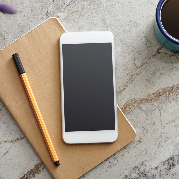Smart Phone and Notebook on the Desk