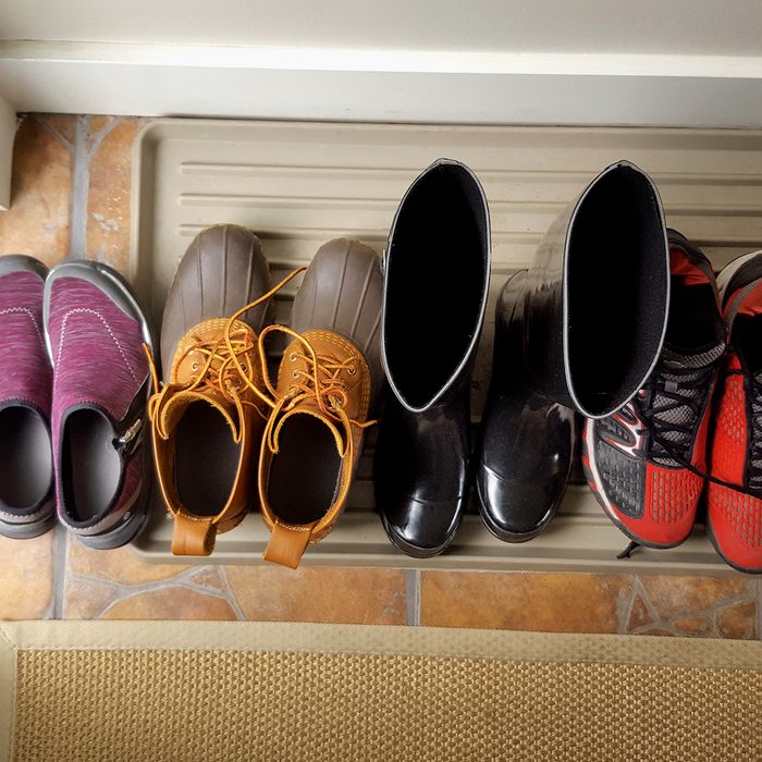 Looking down on Collection of personal shoes,boots,running shoes and rubber boots