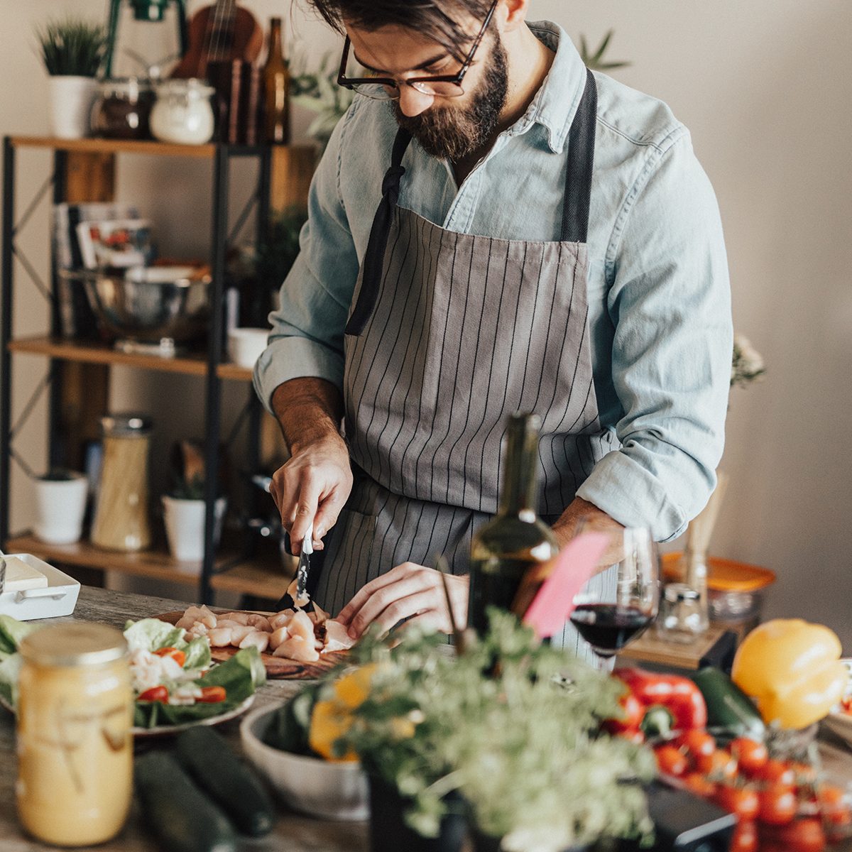 meats for diabetics Young Adult Preparing Meal In The Kitchen