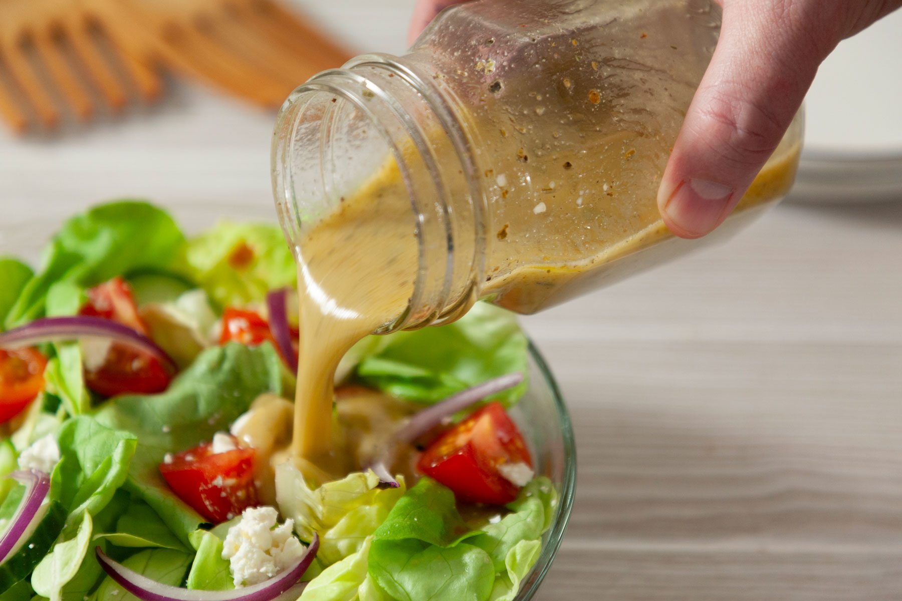 Dressing i poured on the salad