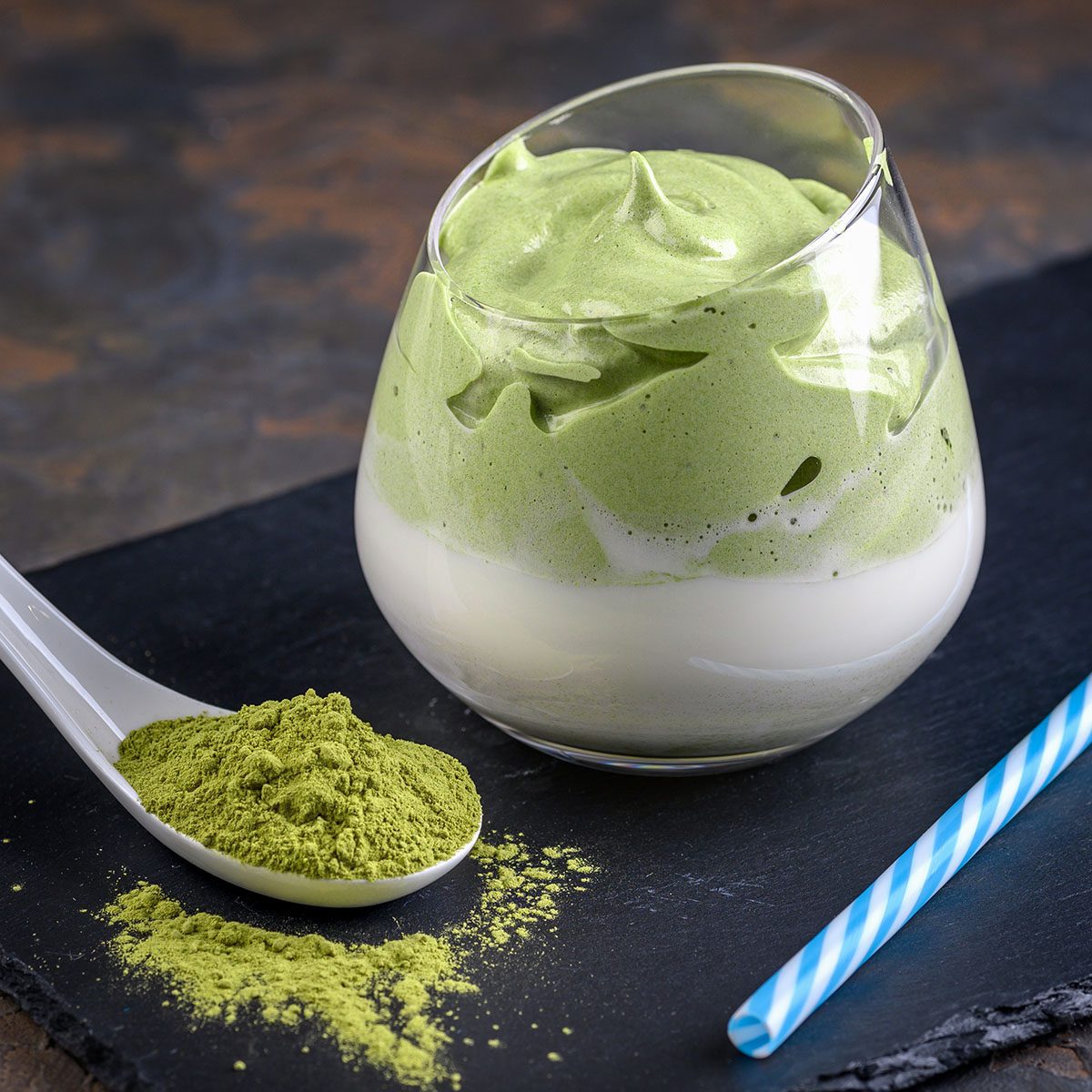 Dalgona Matcha Latte, a creamy whipped matcha, on light background. Matcha green tea.