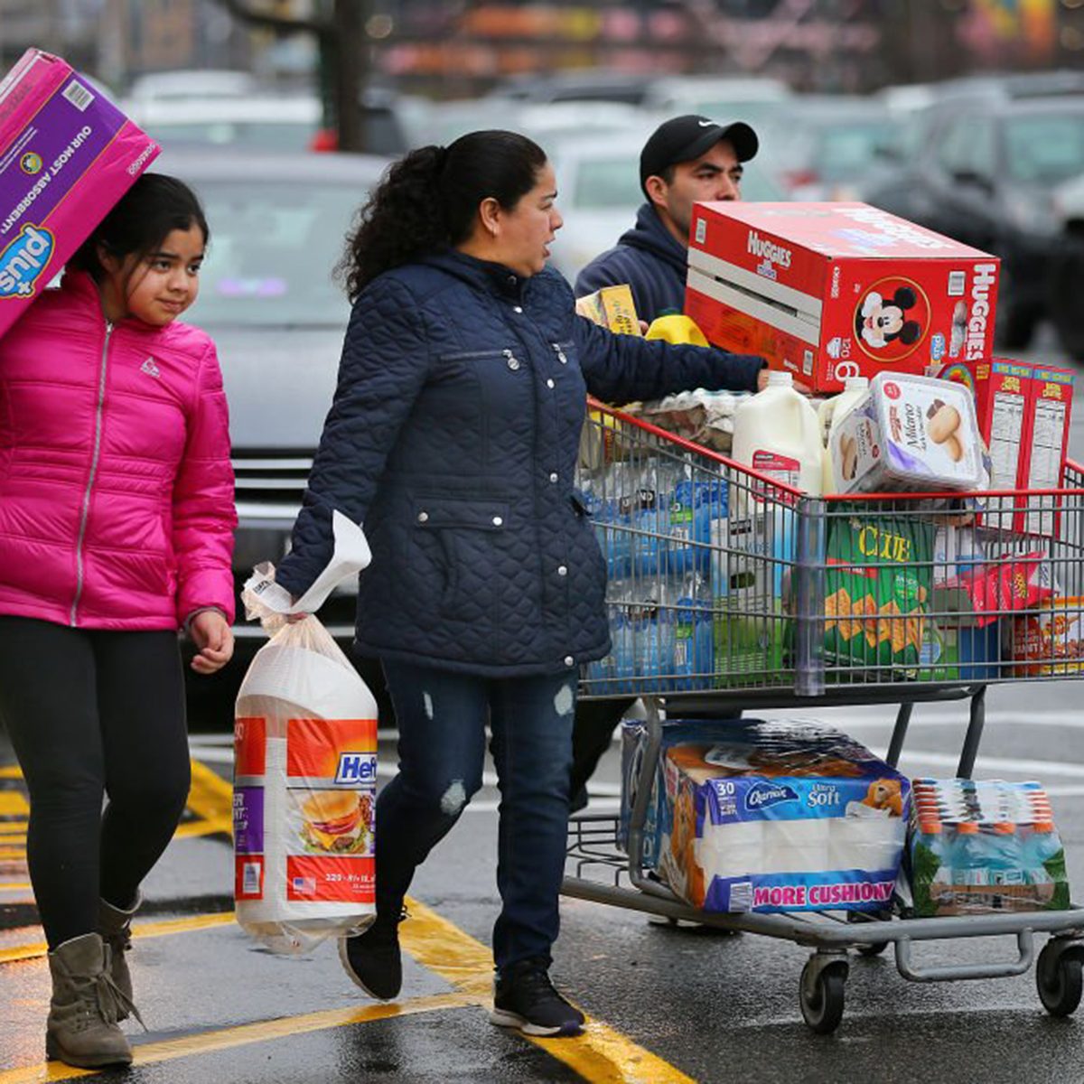 Family carrying items out of a Costco together