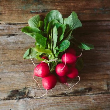 Bunch of red radishes on wood