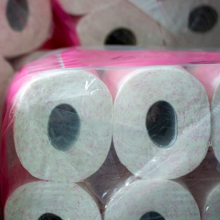 A large stack of toilet paper. A stockpile toilet paper with pink print in packaging. Concept of hoarding products due to coronavirus pandemic