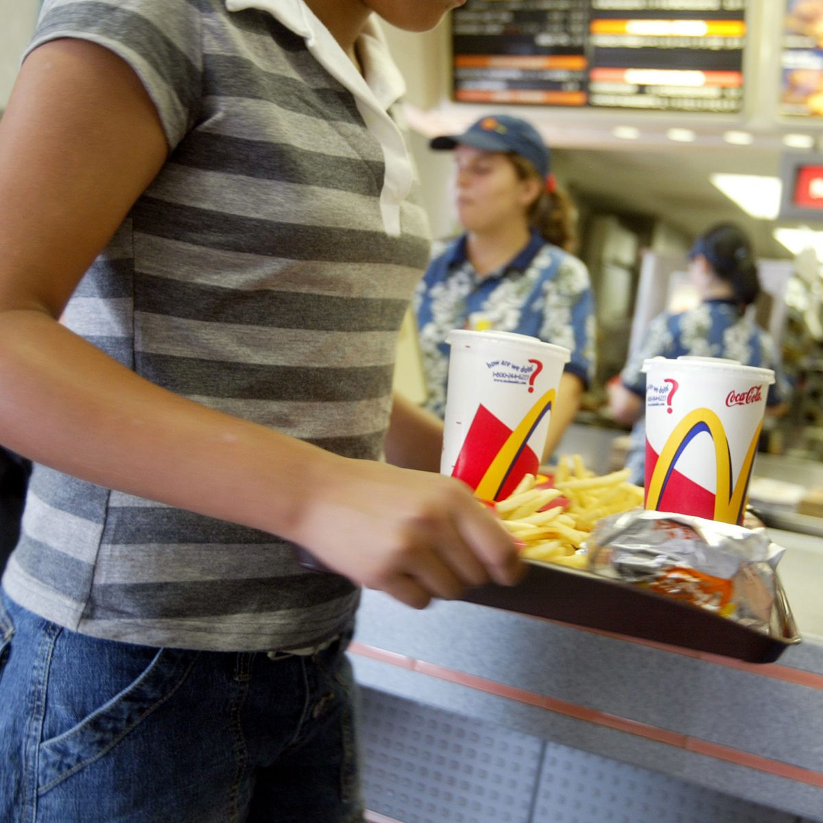 MIAMI, FL - JUNE 19: A customer carries a tray of food at McDonald