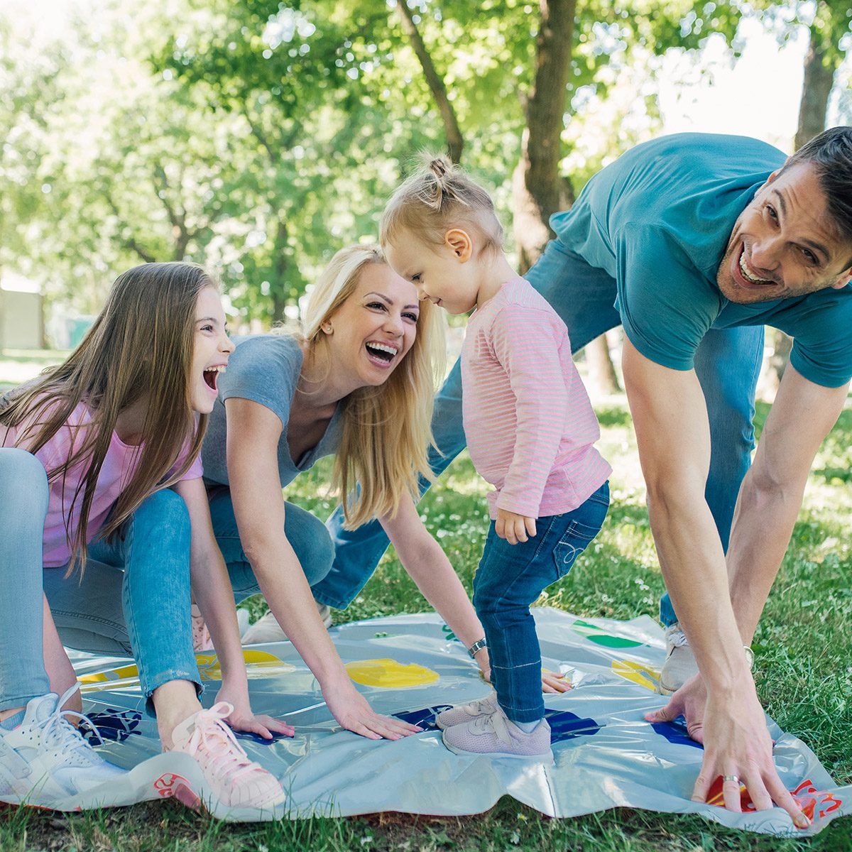 Family with two daughters having game day at the park