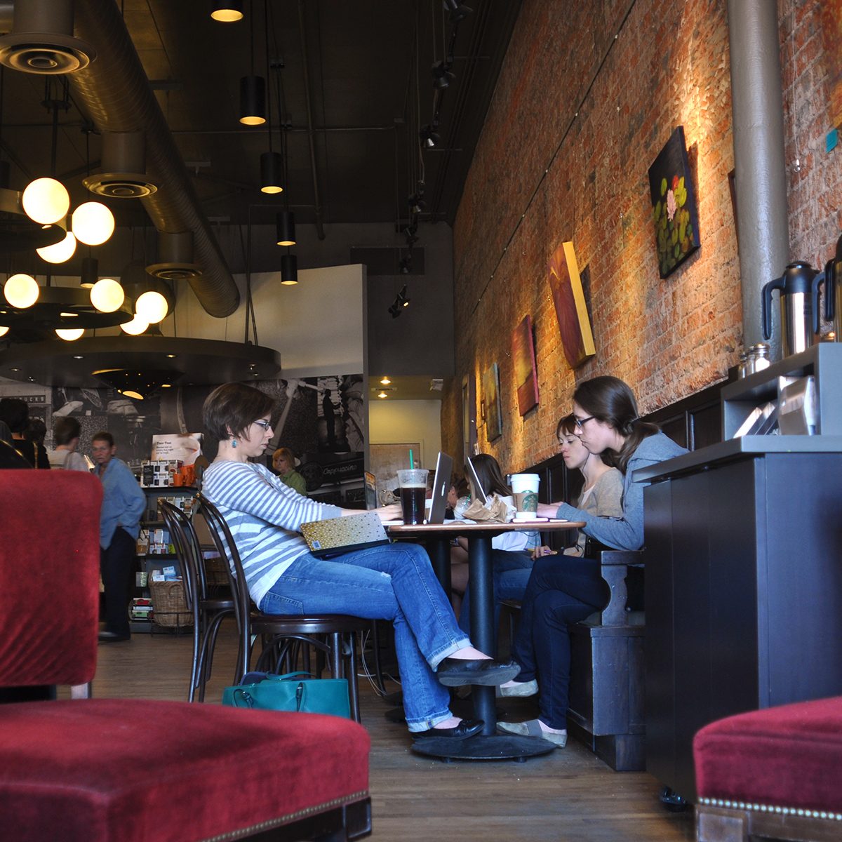 SANTA FE, NM - MARCH 10, 2013: Customers relax and work their laptop computers at a Starbucks coffee shop near the Plaza Santa Fe, New Mexico.