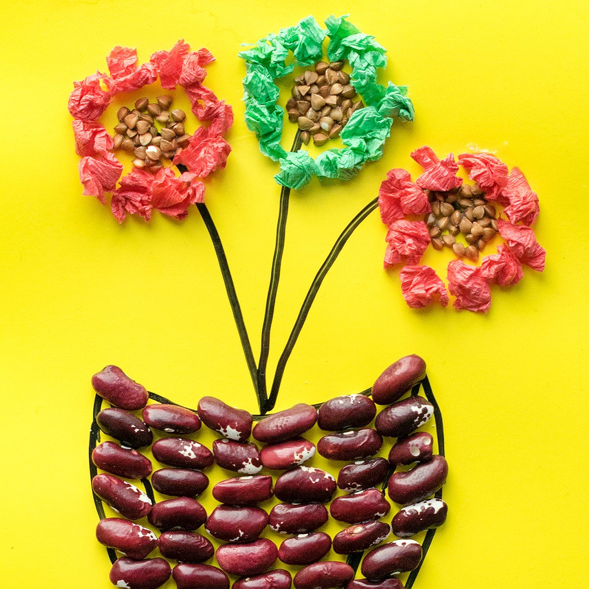 flower in pot from cereals, beans, dried leaves and colored paper Children