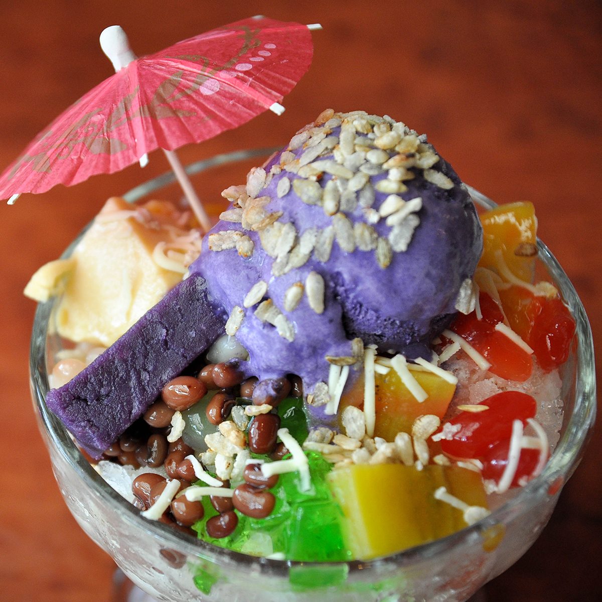 Halo Halo is Filipino dessert of mixed sweetened beans, sweetened fruits, flan, ube jam, shaved ice and milk.