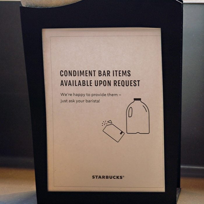 NEW YORK, NY - MARCH 14: A sign is on display at Starbucks offering condiment bar items on request rather then self serve as the coronavirus continues to spread across the United States on March 14, 2020 in New York City. The World Health Organization declared coronavirus (COVID-19) a global pandemic on March 11th. (Photo by Cindy Ord/Getty Images)