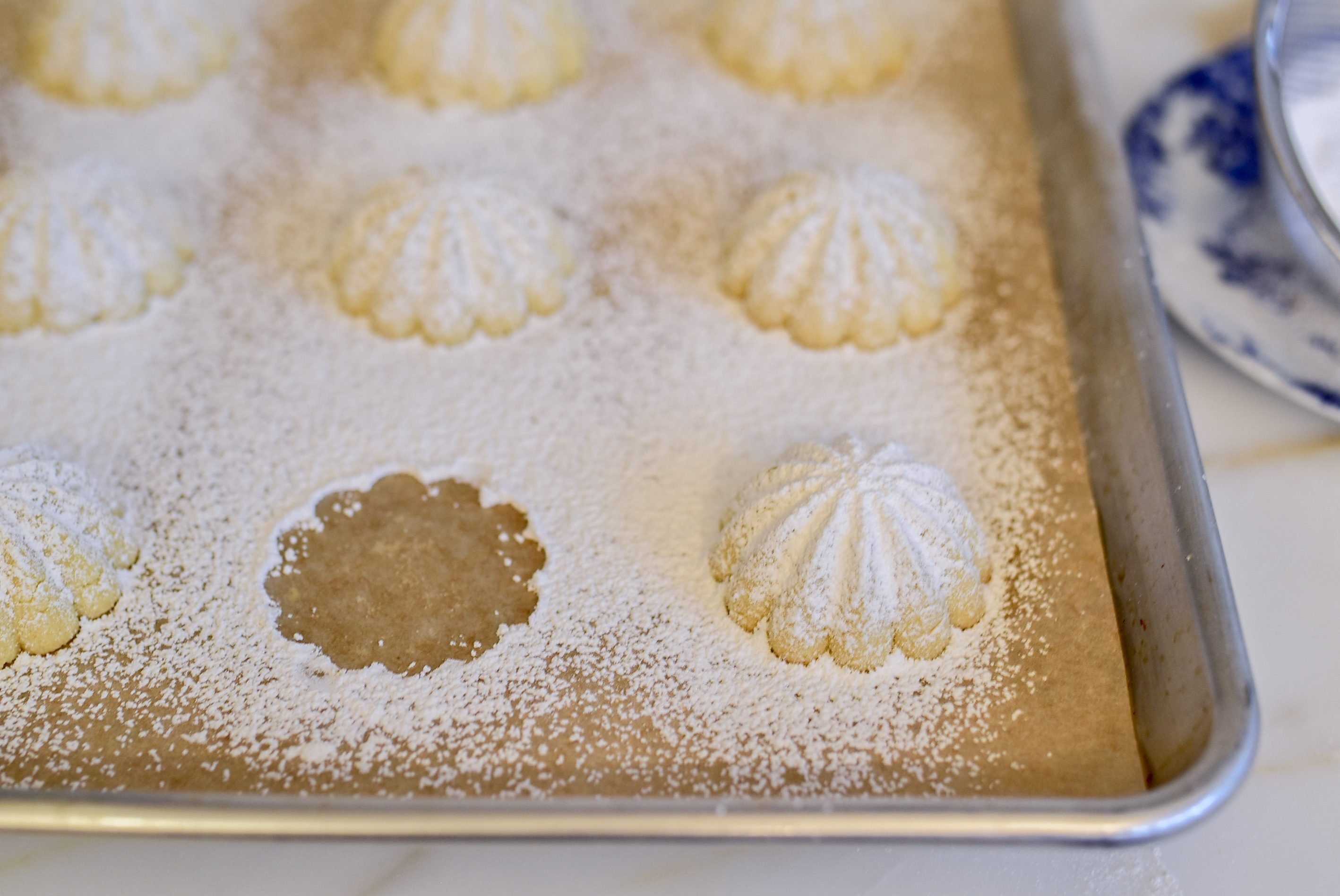 Semolina Ma'amoul on a sheet pan with one missing