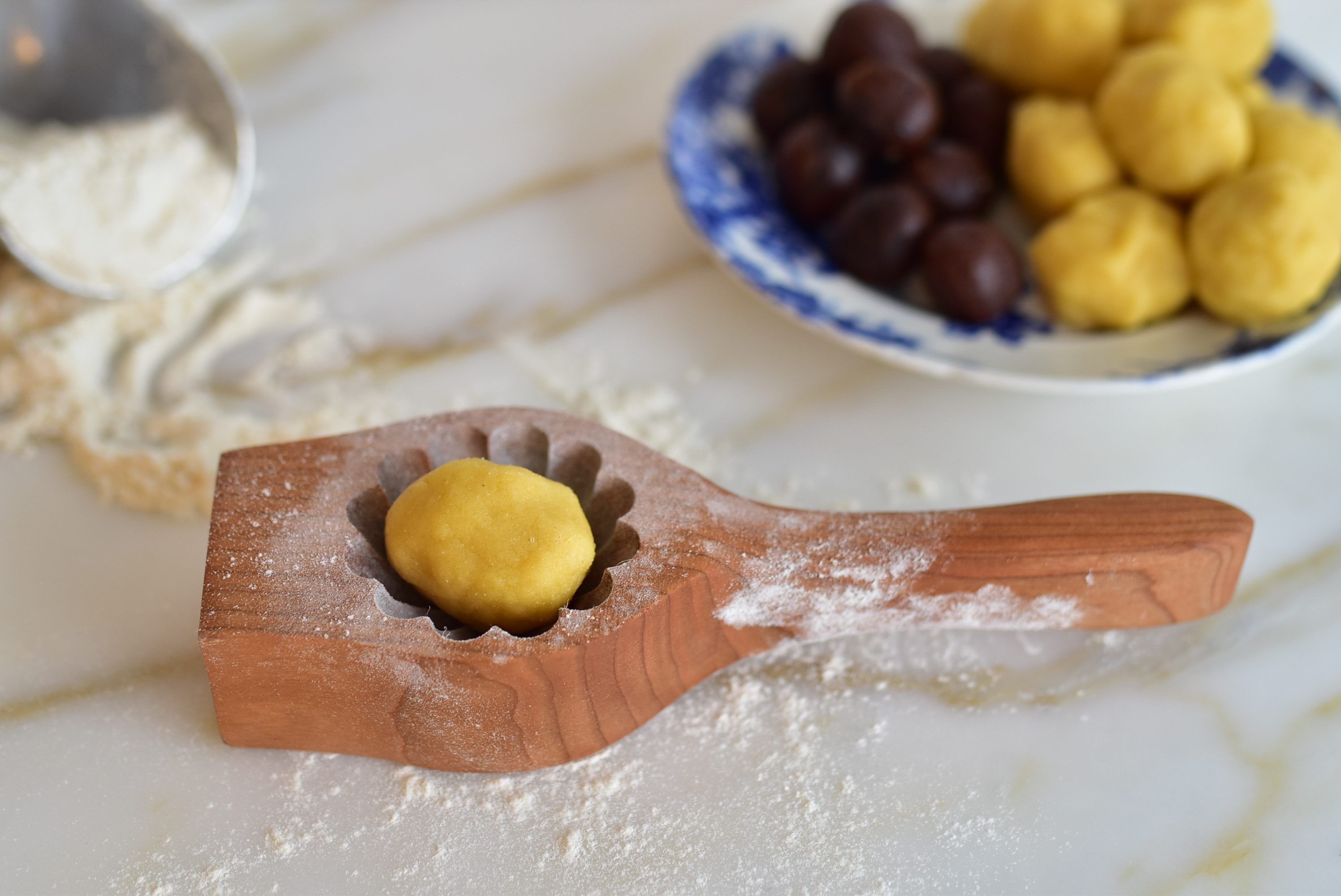 Ma'amoul dough ball in a ma'amoul cookie mold
