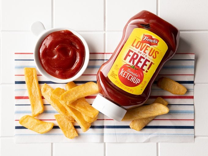 Overhead Shot Of French's Ketchup In Bottle With Fries.