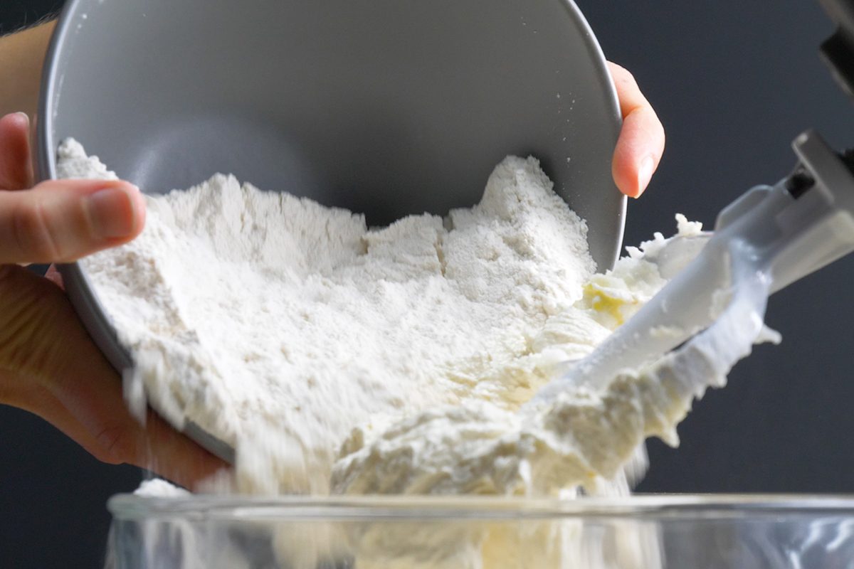 Adding dry ingredients to mixing bowl