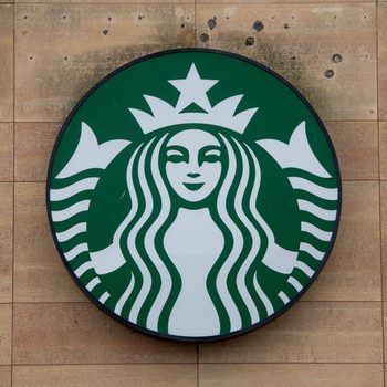 Starbucks logo Sign on wood paneled wall