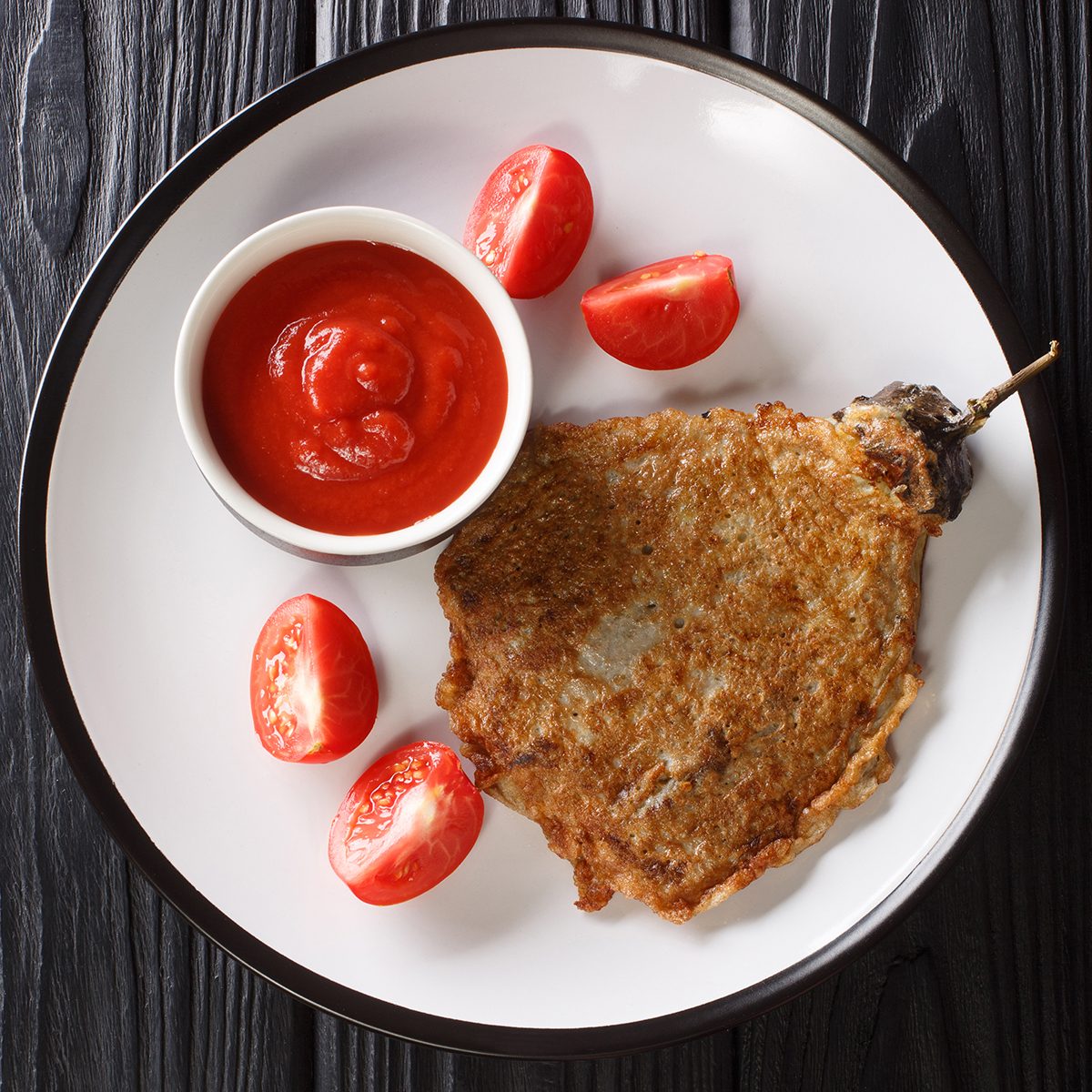 Tortang Talong Is A Filipino Omelette Made By Pan Frying Grilled Whole Eggplants Dipped In An Egg Mixture Close Up In A Plate. Vertical Top View