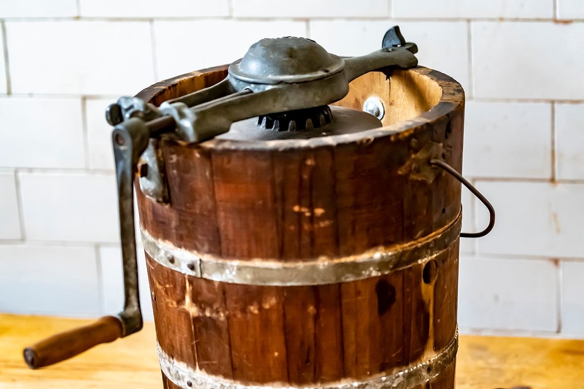 An Old Fashioned Ice Cream Maker With Turning Handle And Makers Mark