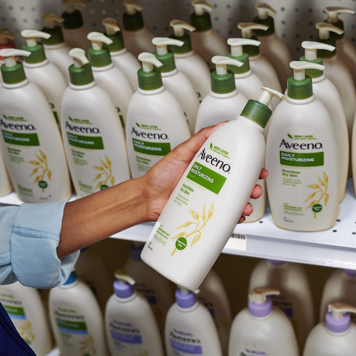 person reaching for aveeno on a shelf